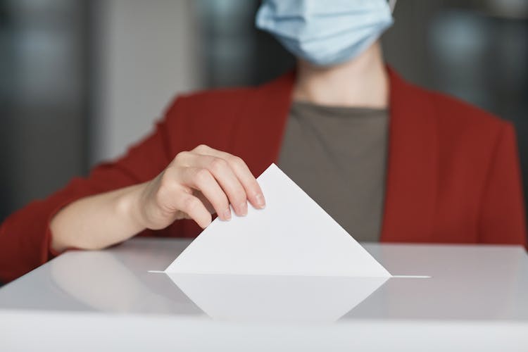 Ballot Box  With Person Casting A Vote