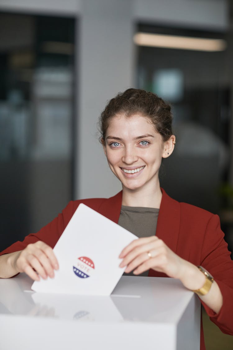 A Woman Putting A Cast Ballot