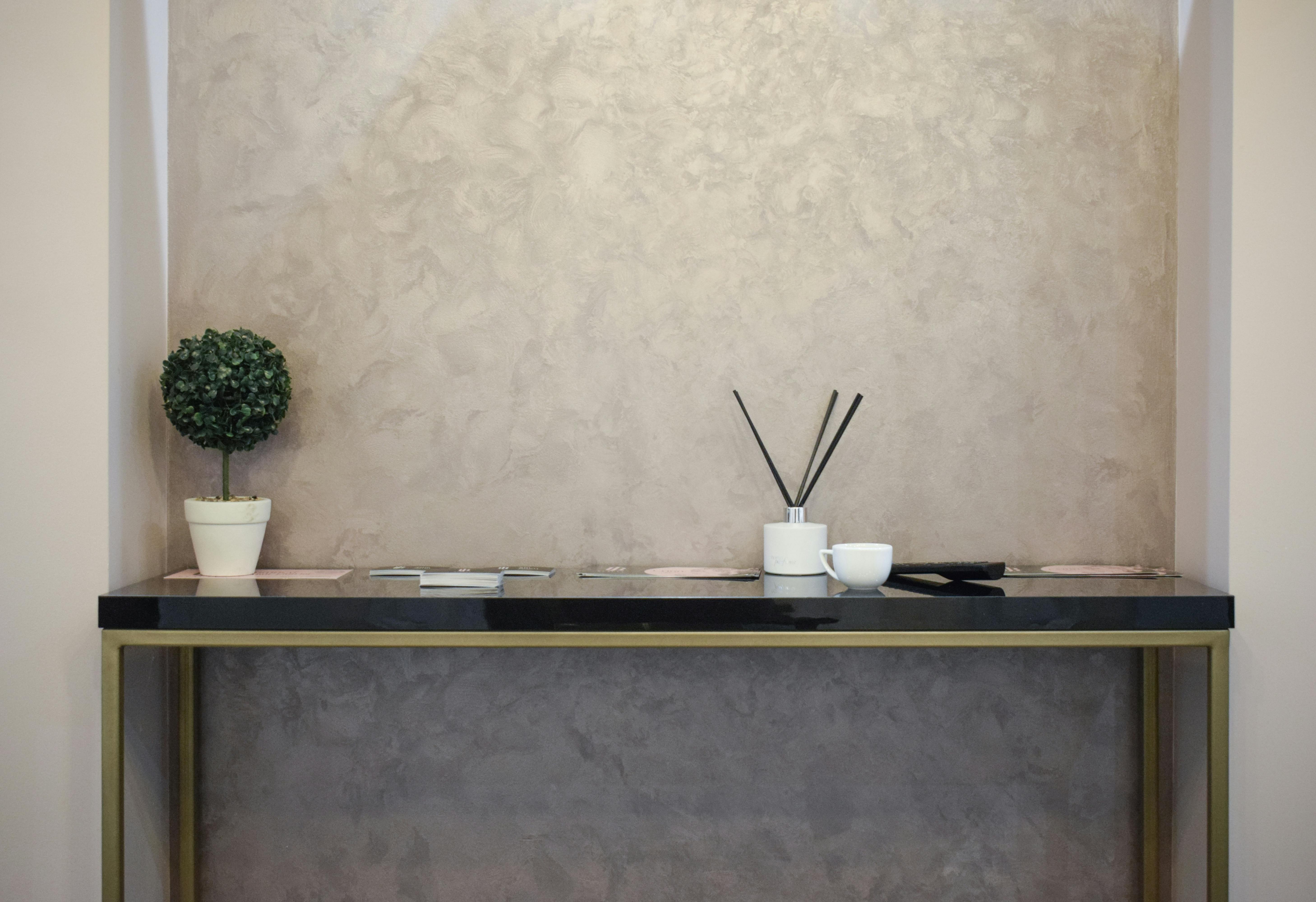 Table with Leaflets, Incense Sticks and a Houseplant on Top of It