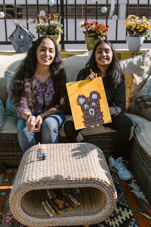 A Girl Holding a Painting