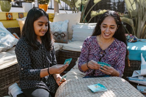 Mother and Daughter Playing Card Game on the Table