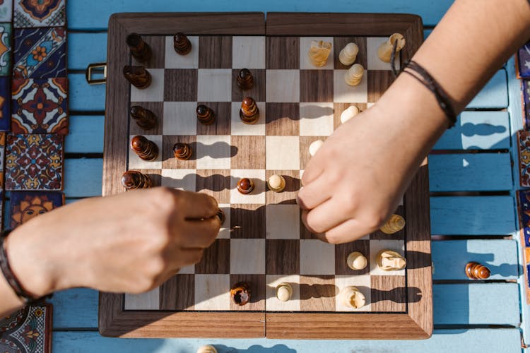 People Playing A Board Game Of Chess