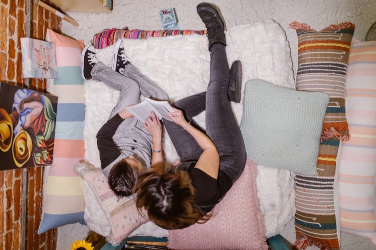 Overhead Shot Of A Woman And Her Son Reading A Book