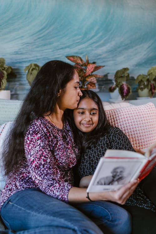 Mother Reading Book with Her Daughter