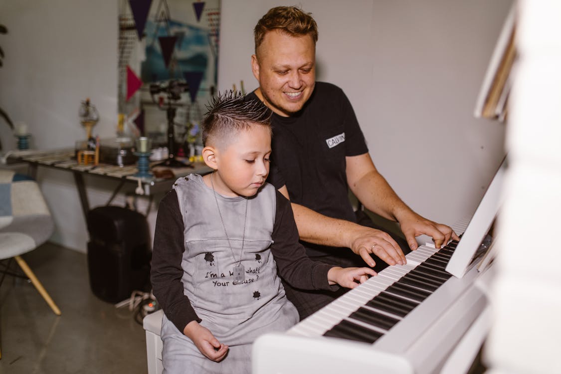 Free Father and Son Playing Piano Stock Photo