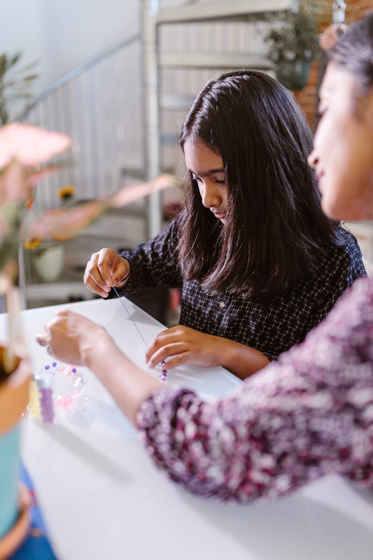 Mother And Daughter Making Beaded Bracelets