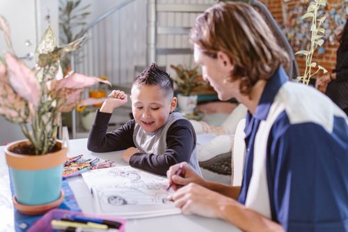 Free Father and son enjoy quality time and creativity while coloring together indoors. Stock Photo