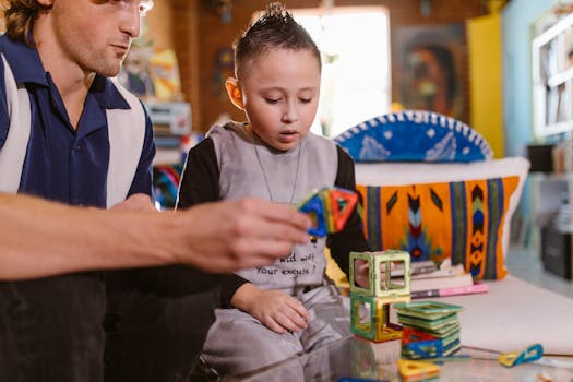 Father and child enjoying creative play with magnetic blocks indoors. Enhances bonding and development.