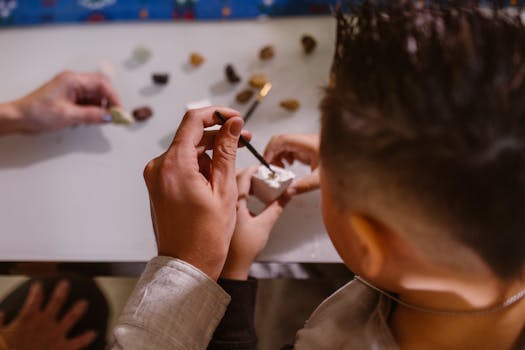 Children participating in a hands-on arts and crafts activity, focusing on creativity and skill development.