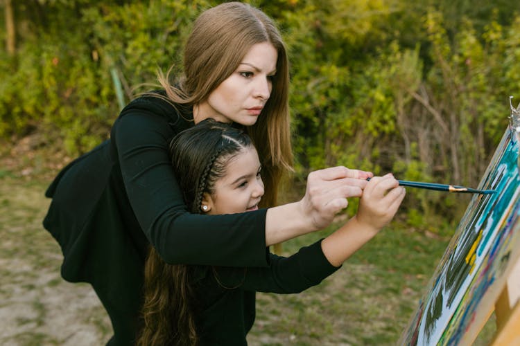 Mother Teaching Her Child To Paint