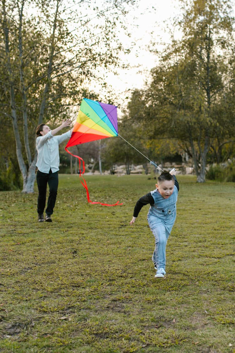 Young Boy Running With A Kite