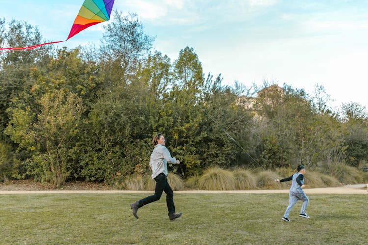 Father And Son Running With A Kite