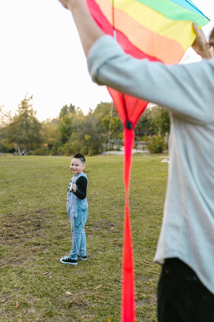 Man And A Kid Flying A Kite