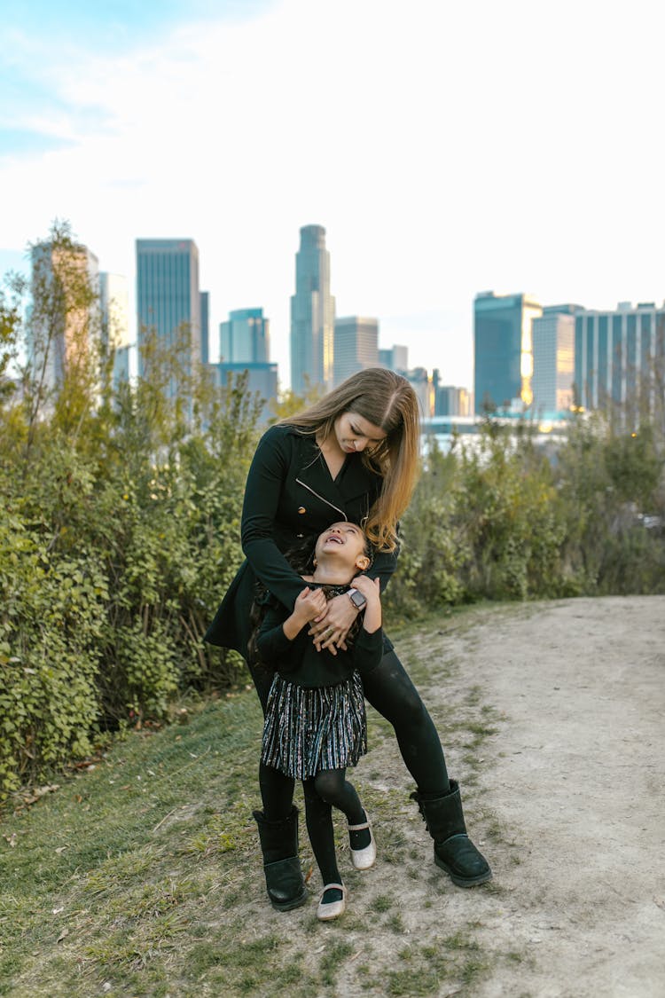 A Woman With Her Daughter At A Park