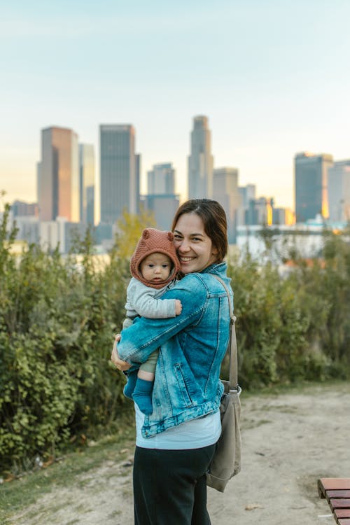 Free A Happy Woman Carrying a Cute Baby Stock Photo