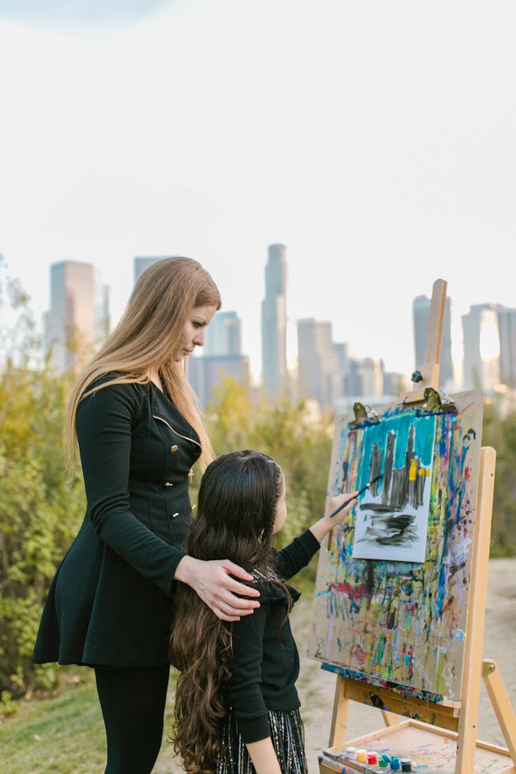 A Child Painting On The Canvass