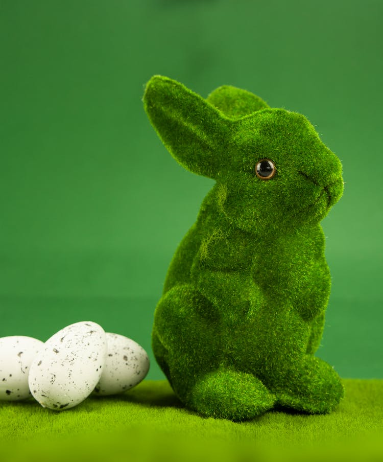 Green Rabbit Plush Toy Beside Eggs 