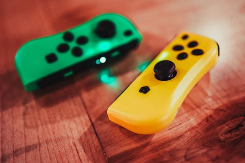 Free From above of gamepads with buttons and glowing light for video game console Stock Photo