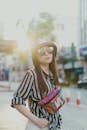Woman in Black and White Striped Long Sleeve Shirt Wearing Bucket Hat and Sunglasses
