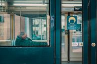 Man in face mask sleeping in train