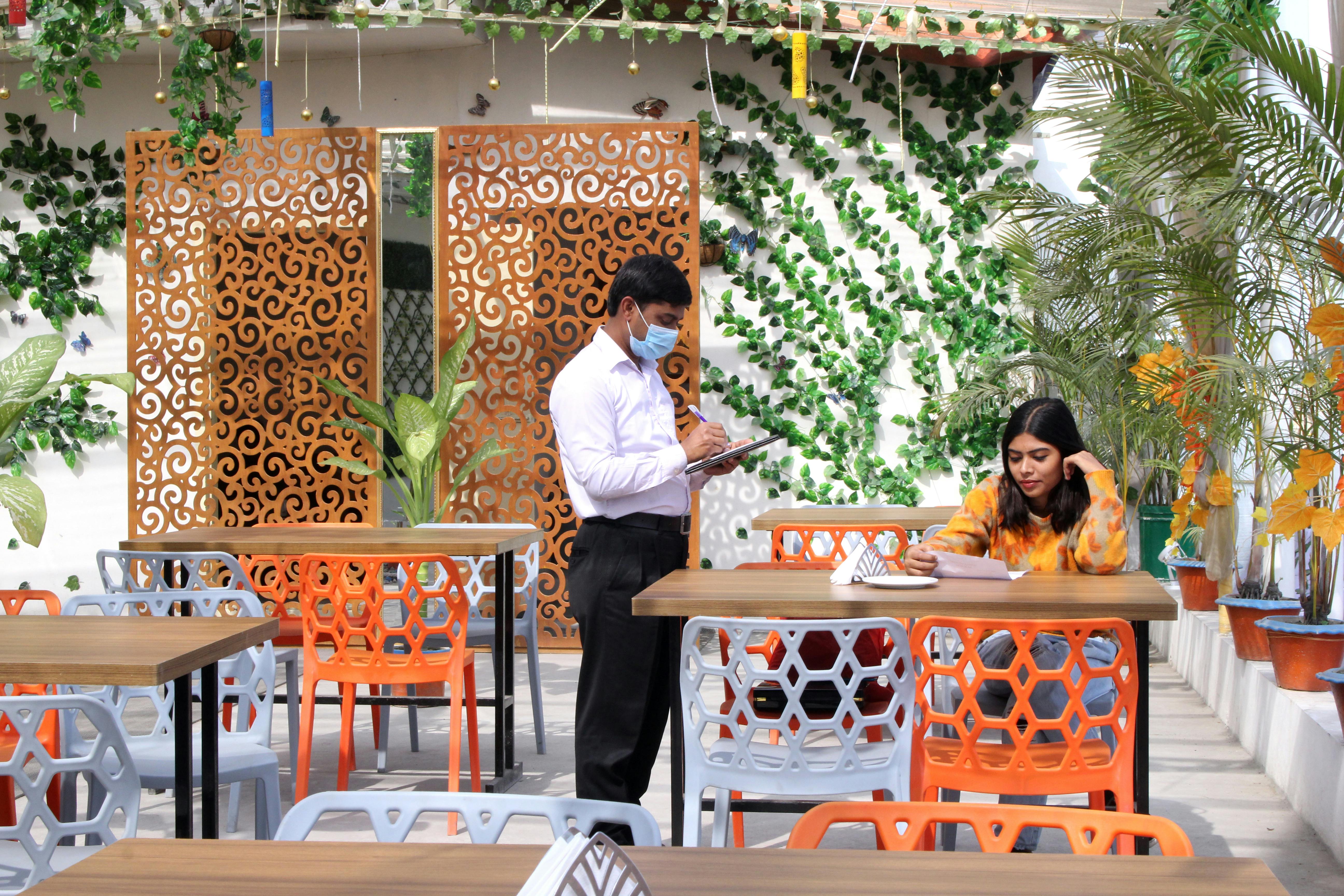 waiter taking order from woman