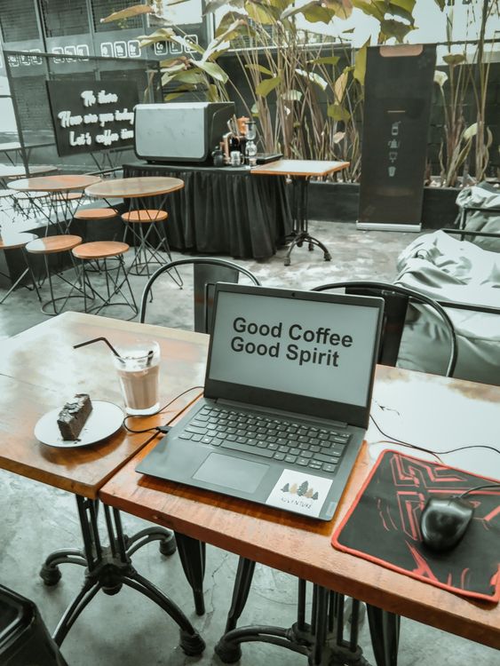 Laptop on Brown Wooden Table Inside a Bar Cafe · Free Stock Photo