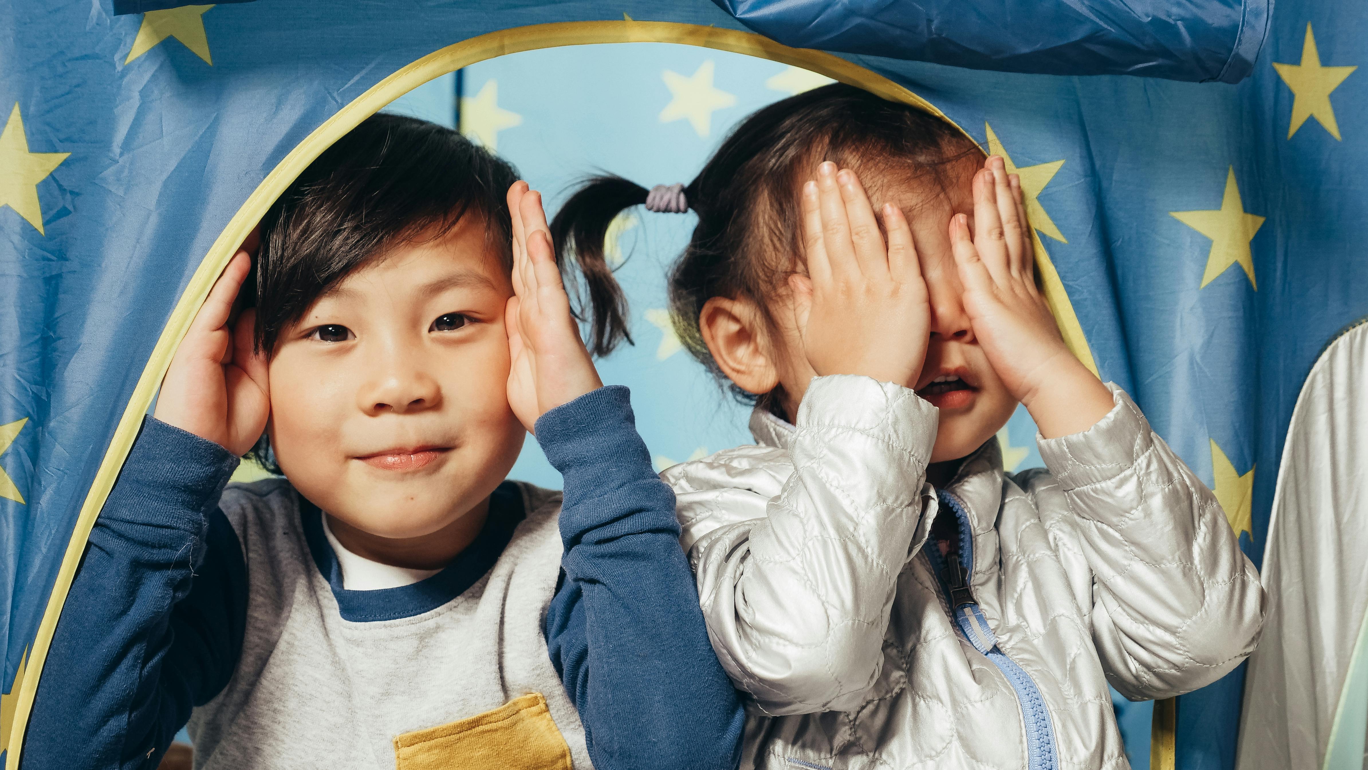 boy and girl playing peek a boo