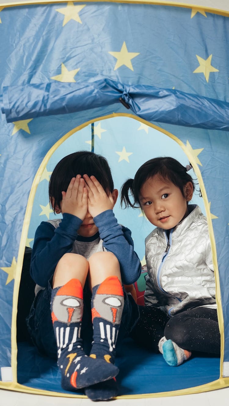 Children Playing Peek A Boo With Boy Covering His Face