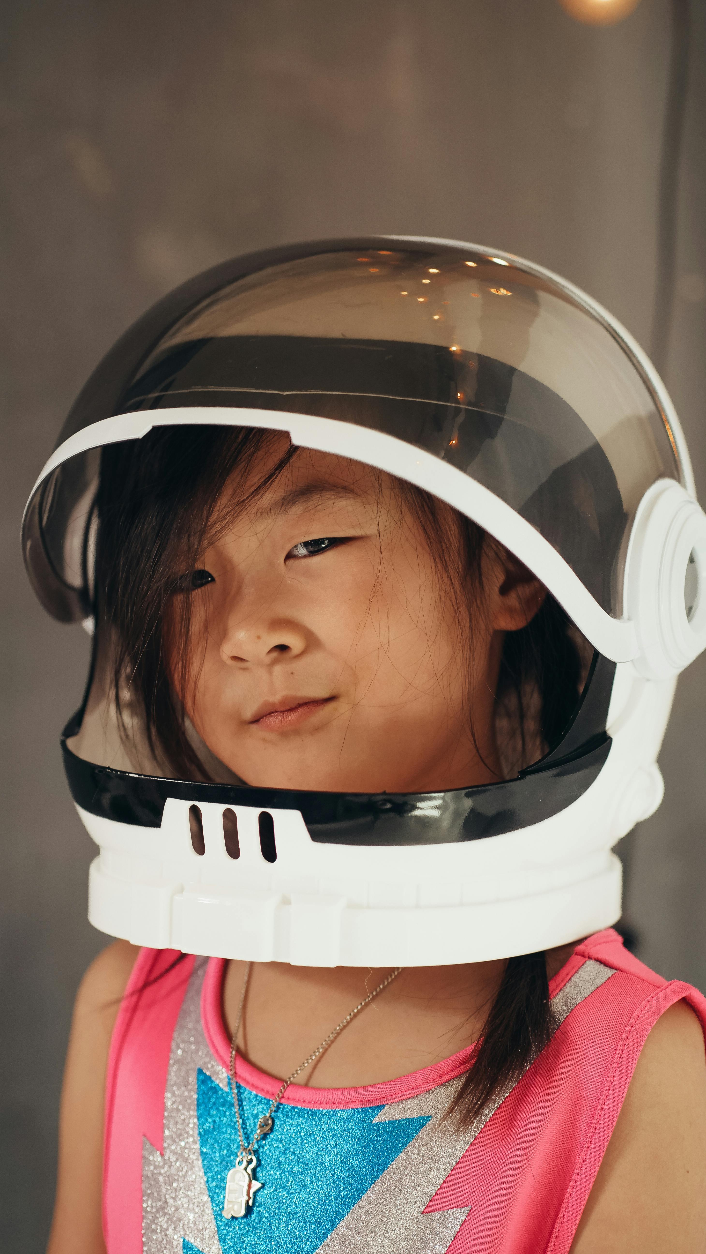 a girl wearing astronaut helmet