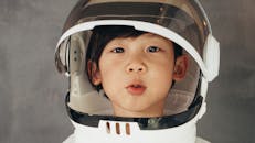 A Boy Wearing Astronaut Helmet