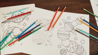Printable planets colouring sheet with coloured pencils — photo by Kindel Media on Pexels