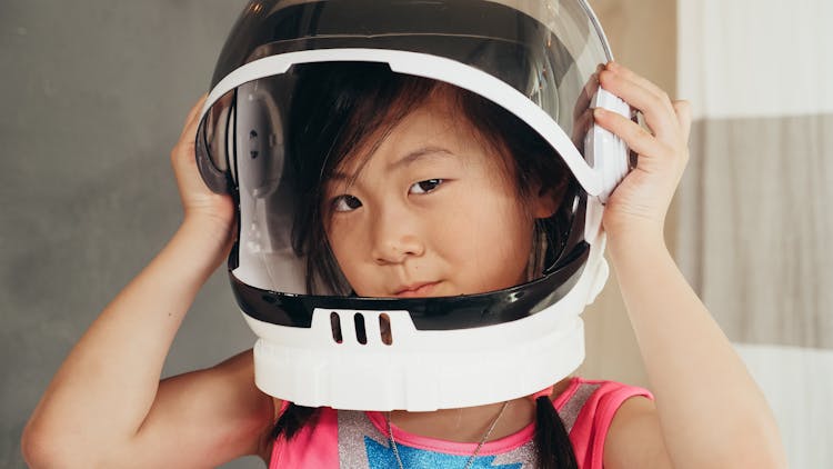 A Girl Wearing Astronaut Helmet