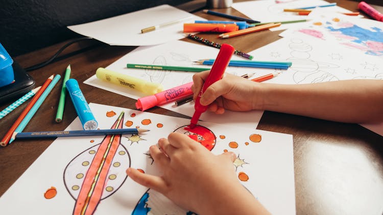 Close-Up Shot Of A Kid Coloring