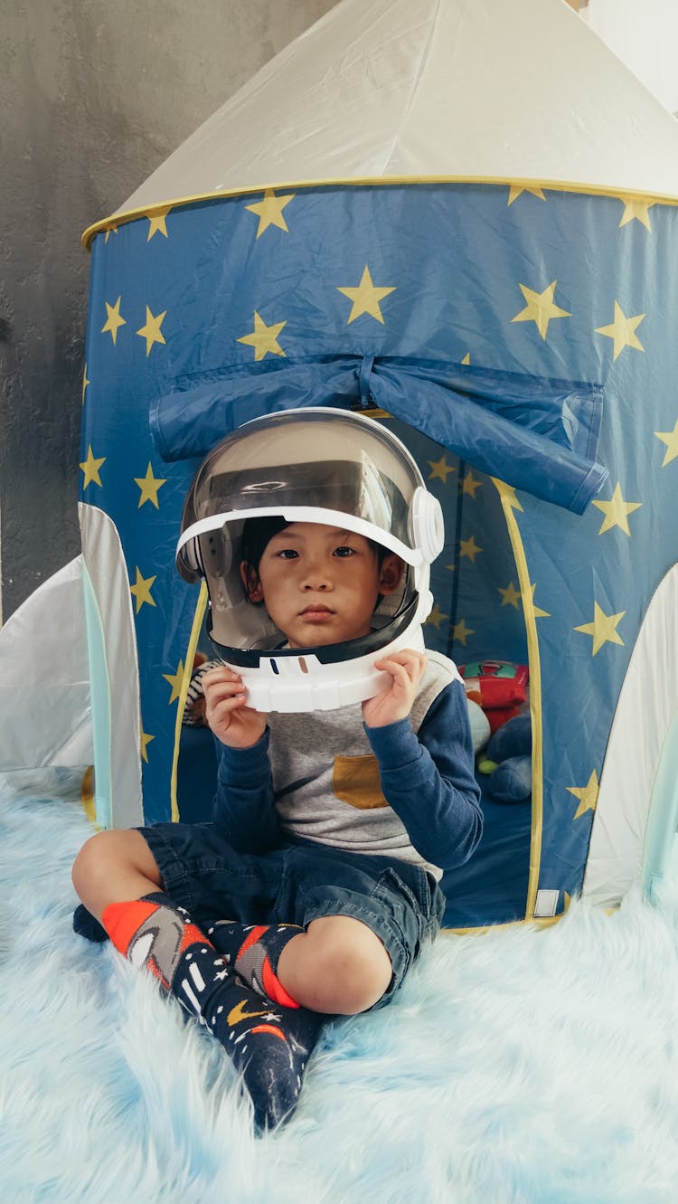 Boy Playing With His Astronaut Helmet