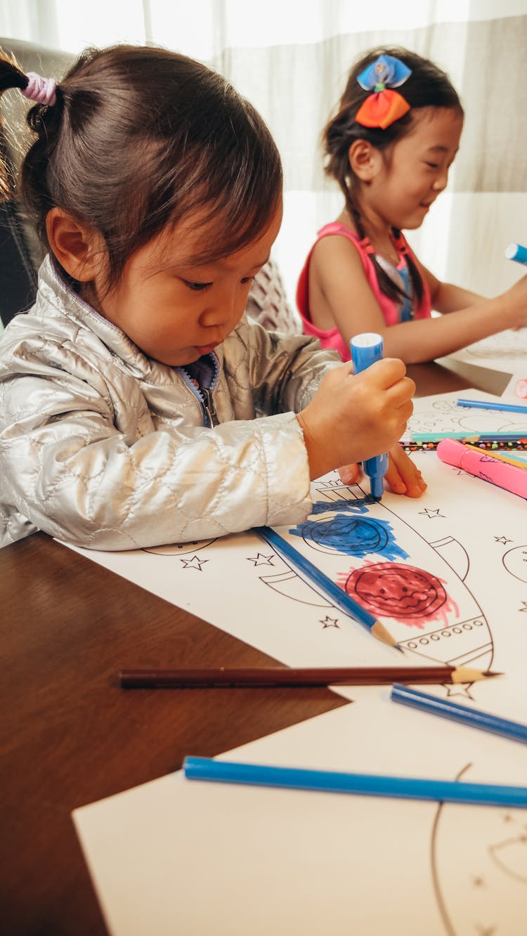 Little Girl Coloring Her Paper