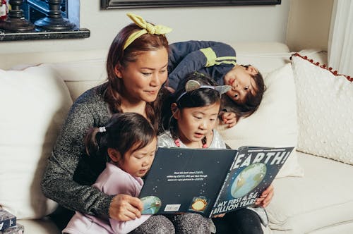 Kostenloses Stock Foto zu asiatische familie, ein buch lesen, kinder