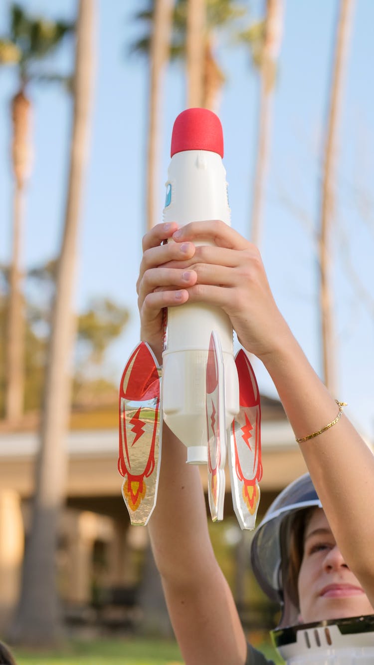 A Person Holding Toy Rocket