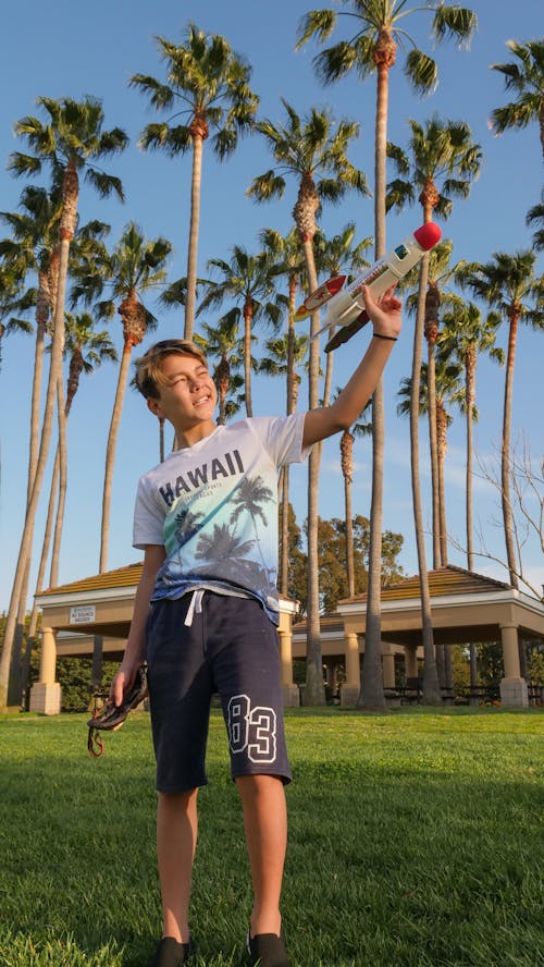 A Boy Holding Playing a Rocket 