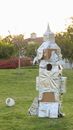 White and Gray Cross Statue on Green Grass Field