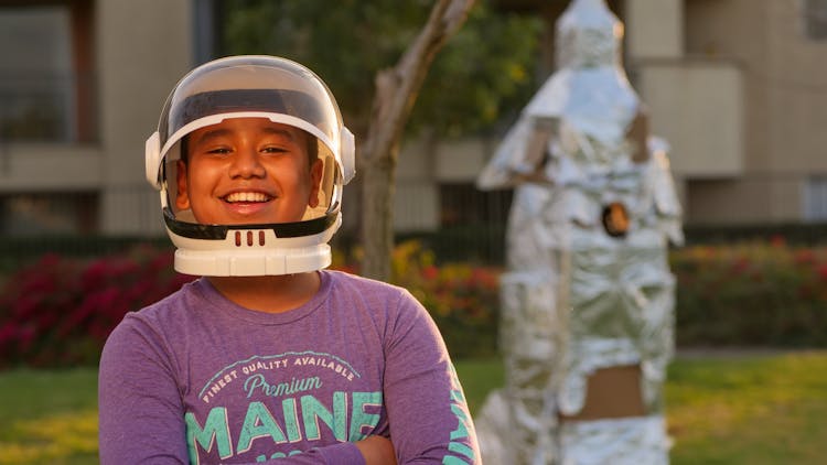 A Boy Wearing A Space Helmet