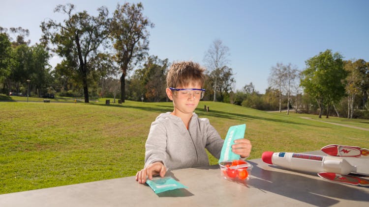 Kid Holding A Plastic Sachet