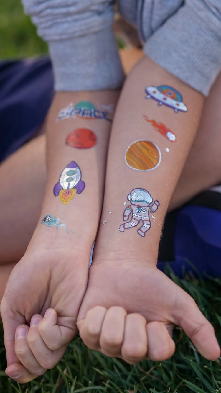 A Boy Showing Arm Paintings Of Space Travel