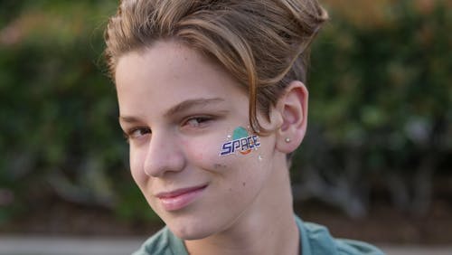 Kid Showing His Sticker on His Face