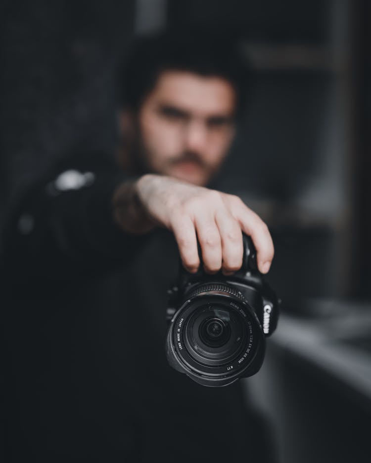 A Man Holding A Camera 