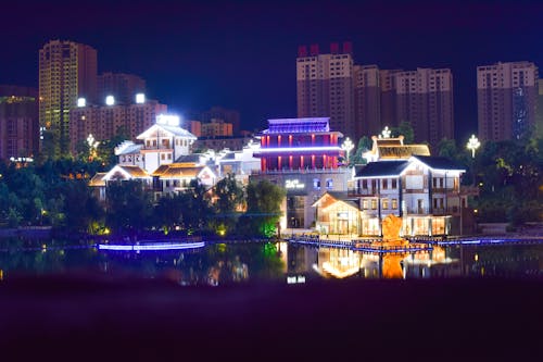 White Concrete House Beside Large Body of Water during Nightime