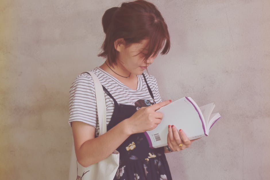 Woman Holding White Book