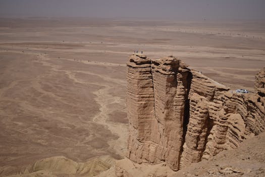 A breathtaking view of the rugged Tuwaiq escarpment rising above the Saudi Arabian desert.