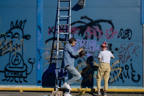 People Vandalizing a Wall