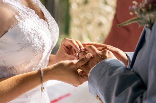 Free Close-up of a couple exchanging rings, capturing the intimacy and emotion of a wedding ceremony. Stock Photo