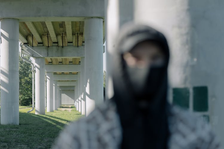 Unrecognizable Person Standing Under Bridge